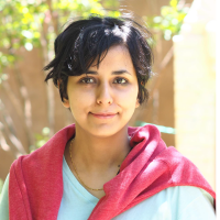 color photograph of a smiling woman with short dark hair