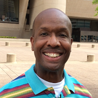 headshot of a smiling man