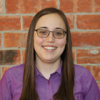 headshot of a smiling woman with glasses and black and white text