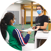 two people in masks holdoing a laptop