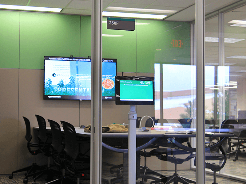 study room with tables, chairs, TV screen