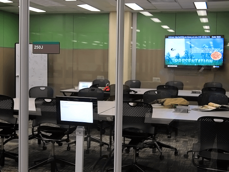 study room with tables, chairs, TV screen