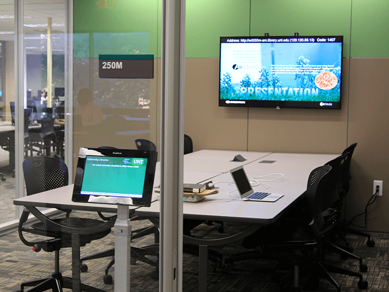 study room with tables, chairs, TV screen