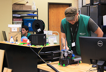 man creating an object with the 3D printer