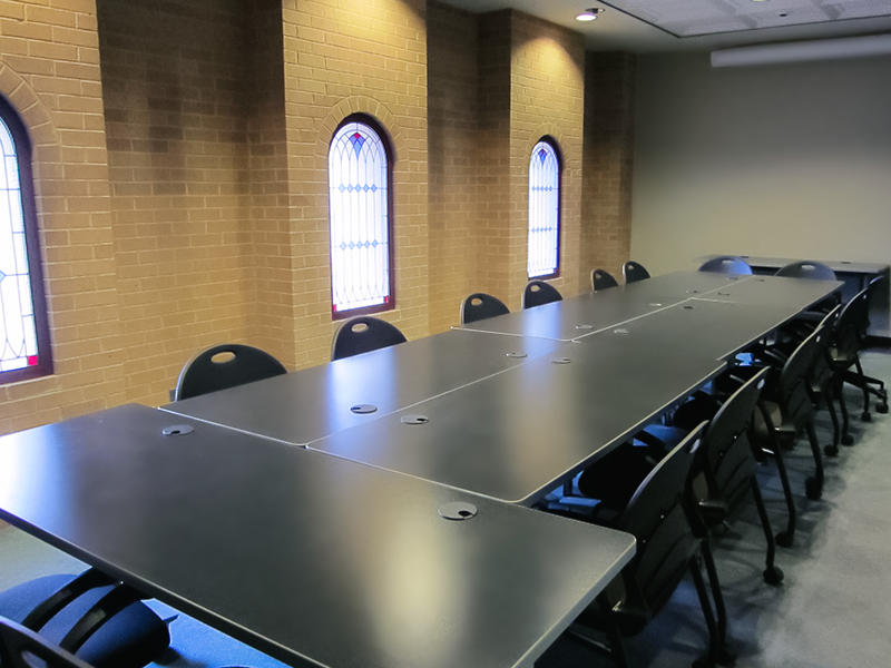 tables and chairs near stained glass windows