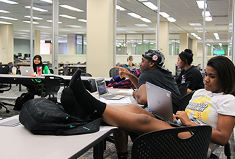 people sitting in chairs at a study table