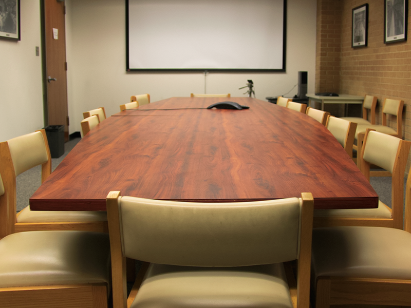 presentation screen, long table and chairs